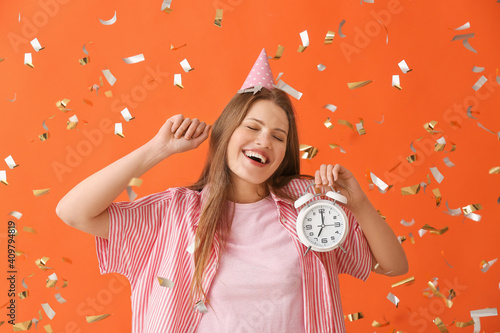 Happy woman with alarm cloc...