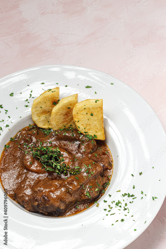 Homemade stew of osso buco meat with aromatic herb sauce