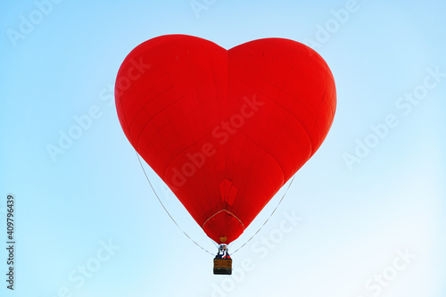 Red heart-shaped air balloon flying in the sky © fotofabrika