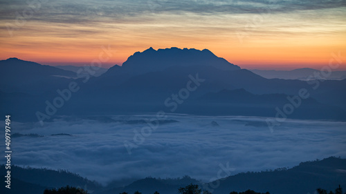 mountain and sea of fog sunrise surrounded with mountain and forest at huai nam dang national park chiang mai, thailand