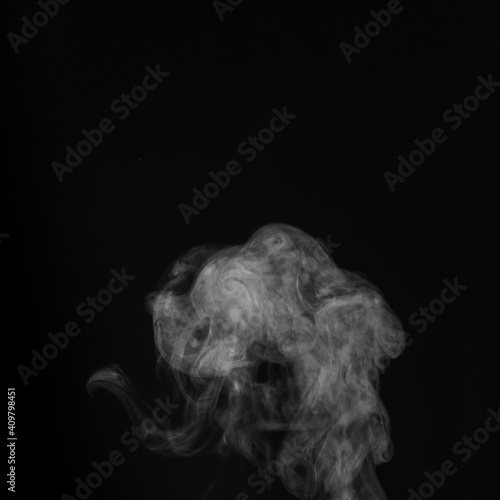 Smoke fragments on a black background. Abstract background, design element, for overlay on pictures. © Alena