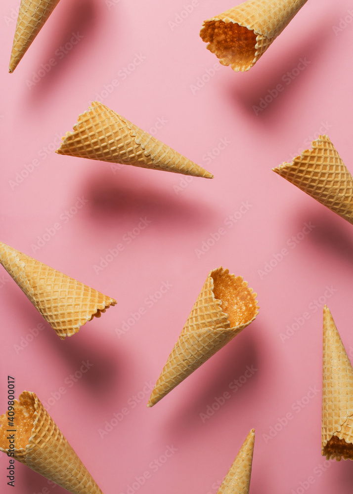 Ice cream cones levitate over pink, pattern background - obrazy, fototapety, plakaty 