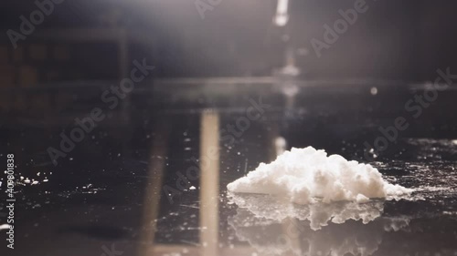 Cocaine junkie snorting line of coke with rolled US dollar bill. Drug Addiction.