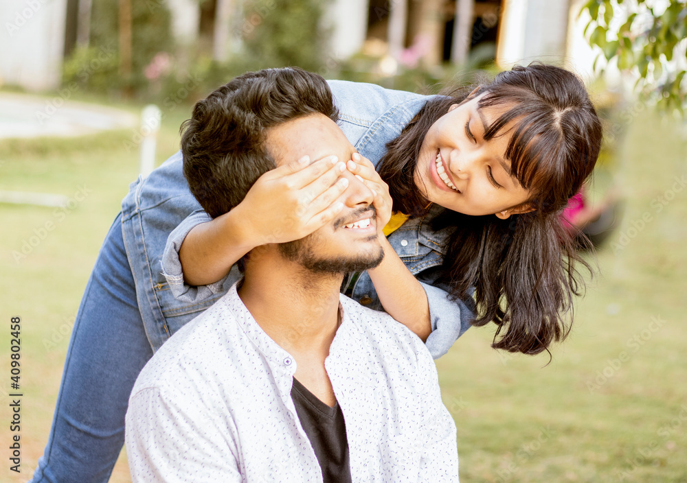 Young girl covering eyes to young surprising boyfriend first meet - Happy couple of lovers, surprise meet or frinds and people having fun Young girl covering eyes to young surprising boyfriend first meet - Happy couple of lovers, surprise meet or frinds and people having fun