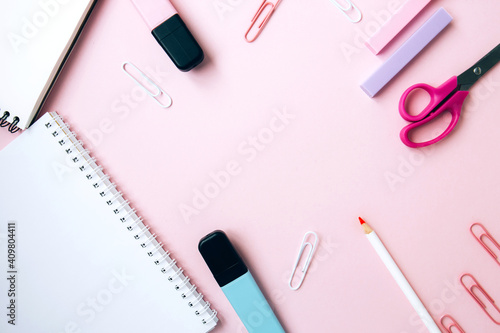 School stationery and supplies on pink background with space for caption. Back to school, homeschool creative workspace. Minimalistic set of colorful stationery. Flat lay