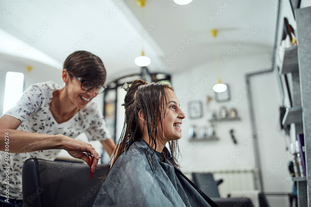 Hairdresser cutting hair in a salon. Hairdresser cutting hair in a salon.