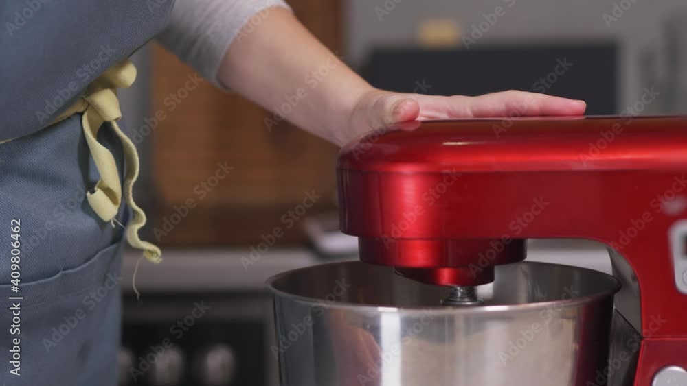 The pastry chef turns on the red planetary mixer. Close-up. High quality 4k footage The pastry chef turns on the red planetary mixer. Close-up. High quality 4k footage
