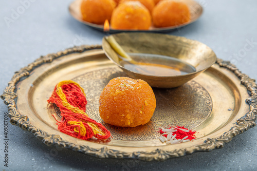 aarti and puja metal plate with ladoo prashad in traditional hindu puja