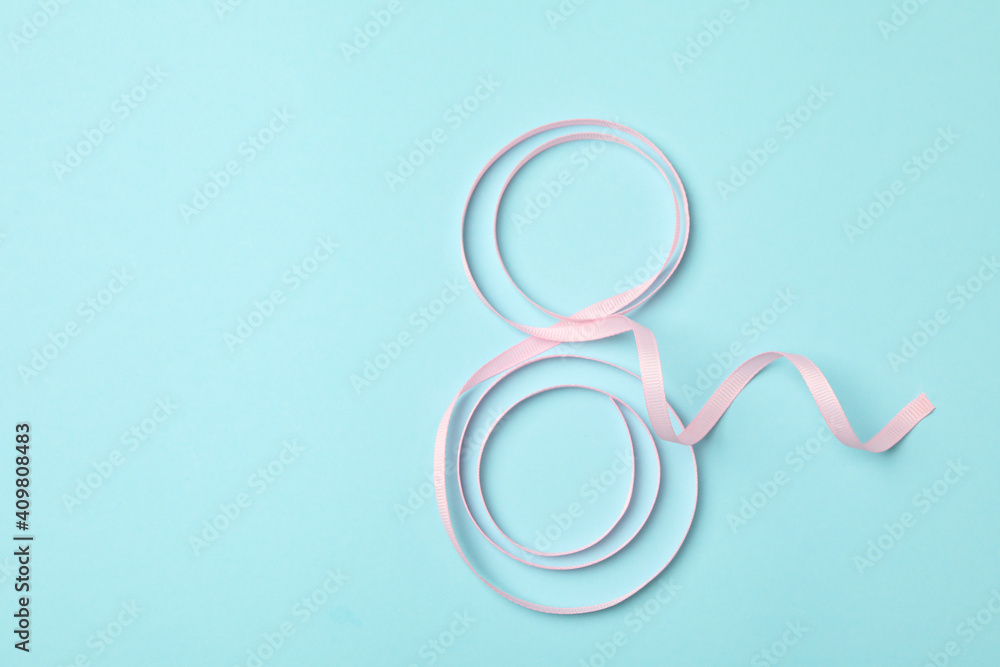 Eight made of ribbon on blue background, space for text Eight made of ribbon on blue background, space for text