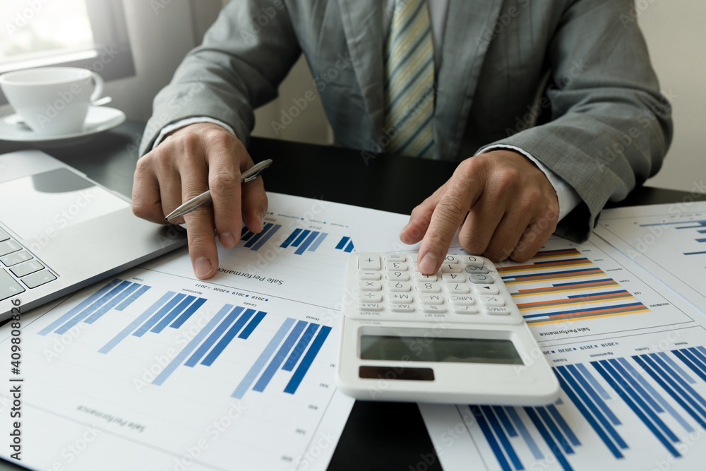 businessman working on desk office with using a calculator to calculate the numbers, finance accounting concept businessman working on desk office with using a calculator to calculate the numbers, finance accounting concept