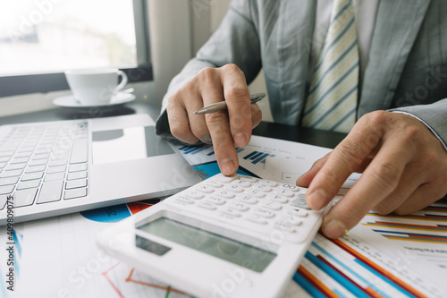 Business people work on the table to analyze financial budgets using a calculator To calculate numbers and liabilities Financial accounting concept