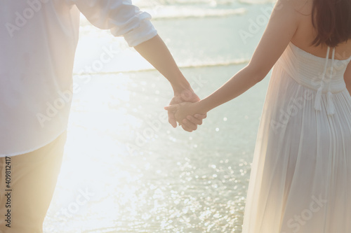 Bild auf Leinwand Love young couple holding hands and running on the beach