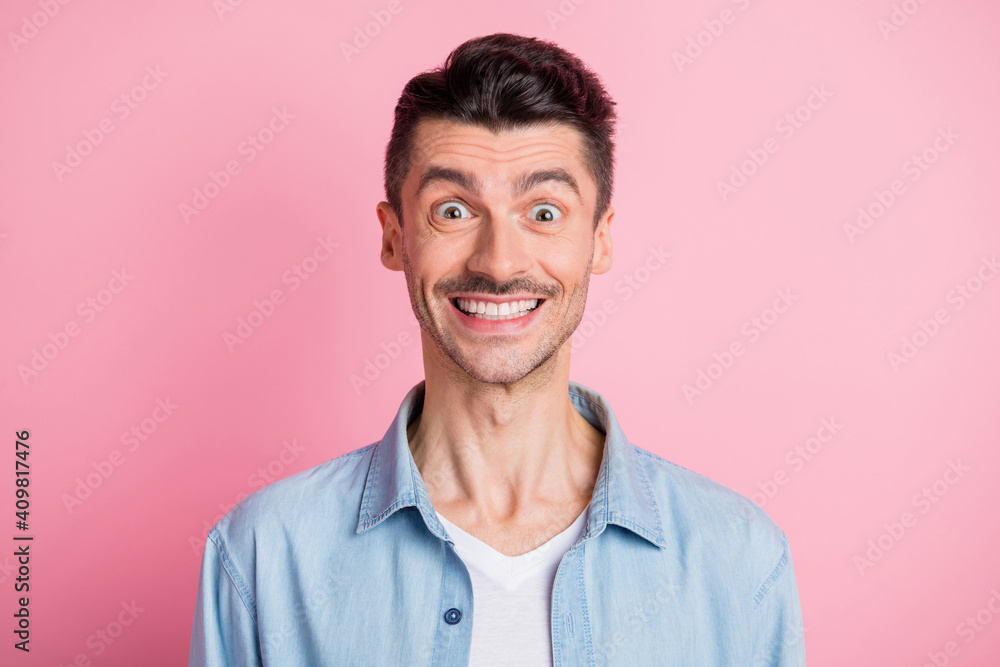 Photo of happy excited charming young man beaming smile wear blue shirt isolated on pink color background Photo of happy excited charming young man beaming smile wear blue shirt isolated on pink color background