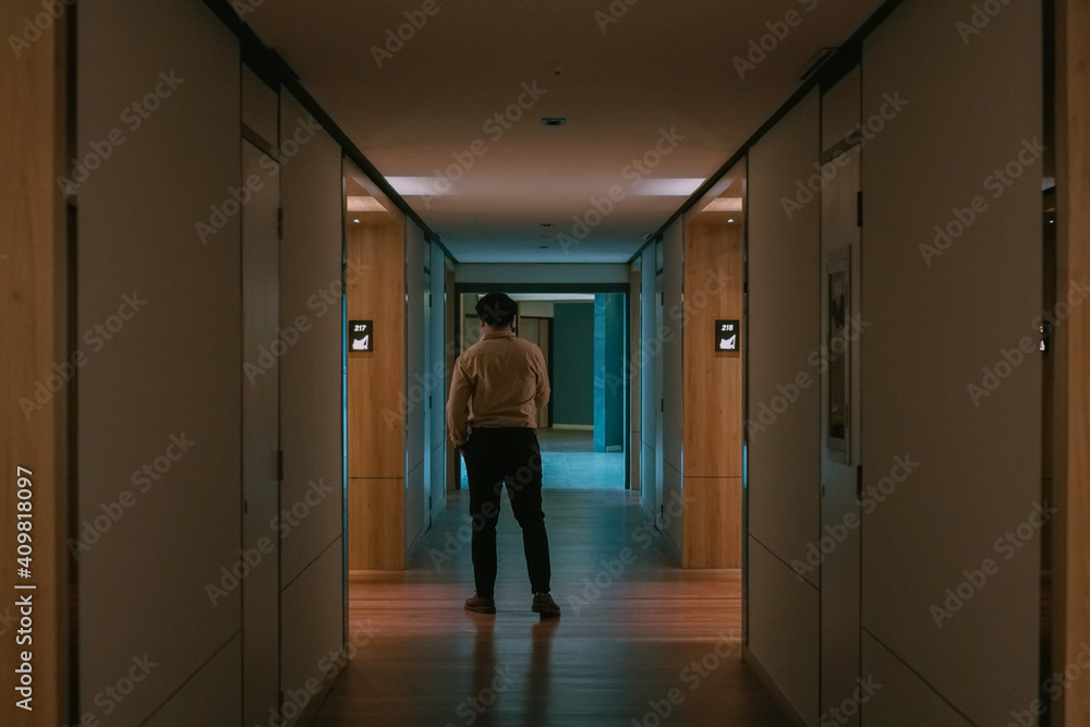 Man walk alone in the middle of corridor Man walk alone in the middle of corridor