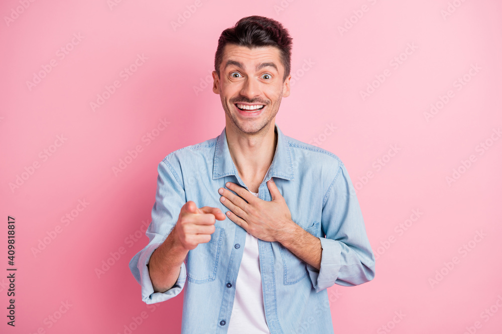 Portrait of nice cheerful guy pointing at you laughing mocking isolated over pink pastel color background Portrait of nice cheerful guy pointing at you laughing mocking isolated over pink pastel color background