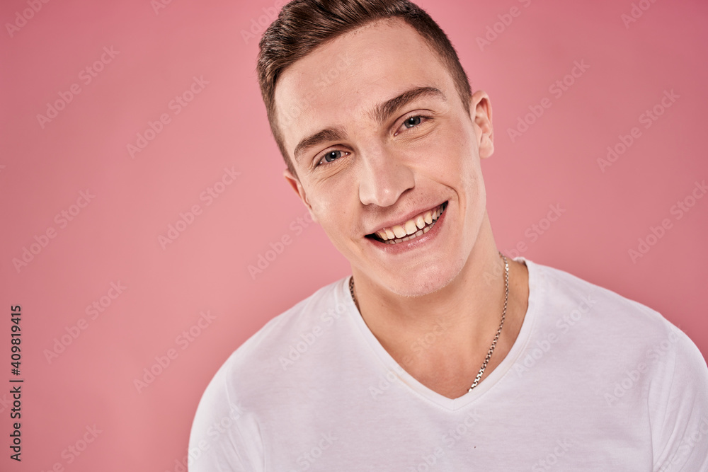 cheerful man in white t-shirt smile emotions close-up pink background studio cheerful man in white t-shirt smile emotions close-up pink background studio