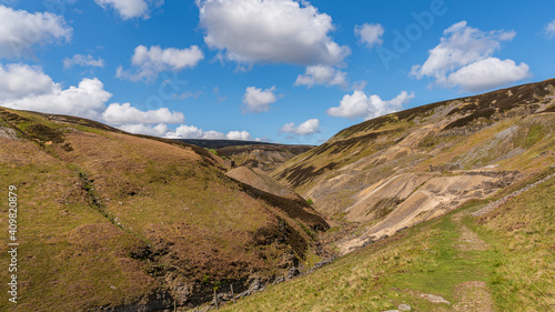 Walking at the Gunnerside Gill with the Bunton Mine and Blakethwaite Mine in the background  North Yorkshire  England  UK