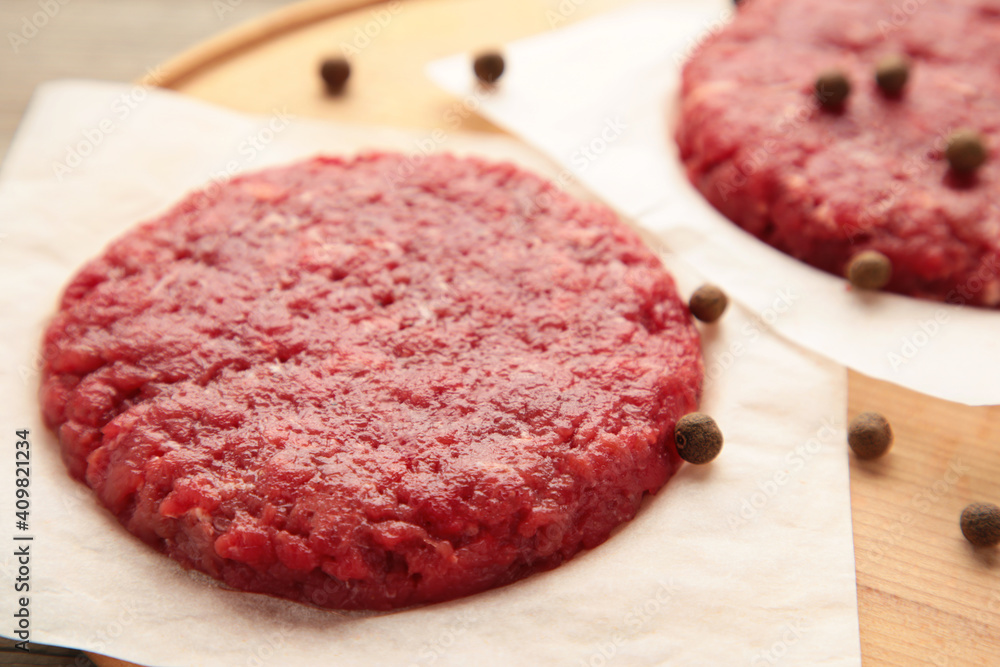 Raw cutlet for hamburger on a grey background Raw cutlet for hamburger on a grey background