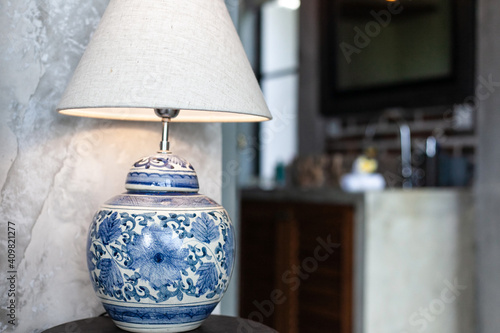 Fotografie a large ceramic lamp with blue patterns on a white background and a lampshade st