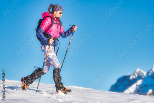 Snow hike with light crampons. A young woman