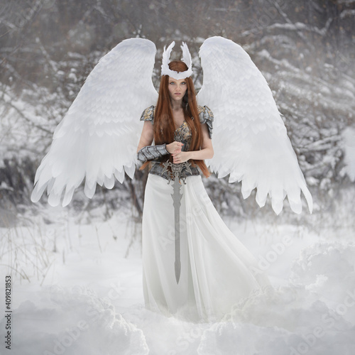 Art photo of an angel woman with white wings and a valkyrie sword photo