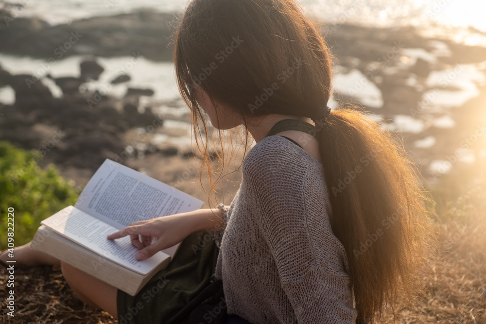 One asian woman and a book with sea view One asian woman and a book with sea view