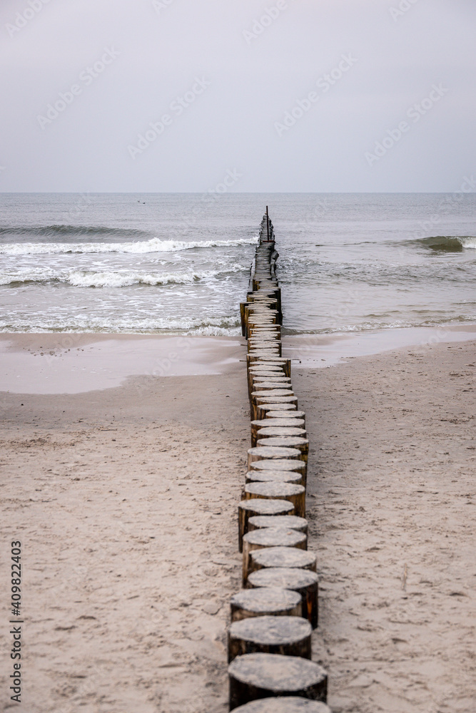 seaside landscape of the baltic sea on a calm day with a wooden breakwater seaside landscape of the baltic sea on a calm day with a wooden breakwater