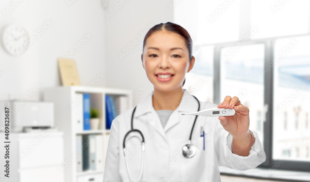 medicine, profession and healthcare concept - happy smiling asian female doctor with stethoscope and thermometer over medical office at hospital on background medicine, profession and healthcare concept - happy smiling asian female doctor with stethoscope and thermometer over medical office at hospital on background