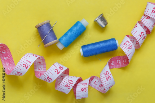 Sewing accessories on a yellow background, flatley.