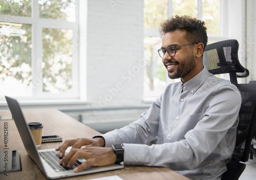 Confident businessman working on laptop at his workplace at modern office, Young handsome student men using laptop computer, Business, working moments, freelance, distance education concept