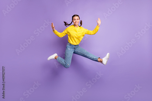 Photo of sweet charming young woman braids wear yellow pullover jumping high isolated purple color background