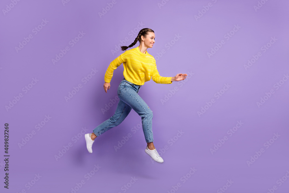Photo of shiny purposeful young woman braids wear yellow pullover jumping running isolated purple color background