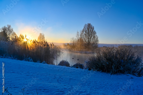 sunrise and mist over small pond i Kumla lakepark Sweden © Jonas