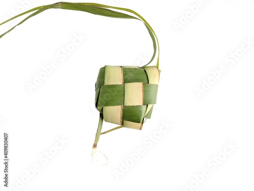 Ketupat or rice dumpling is a local delicacy during the festive season. Ketupats, a natural rice casing made from young coconut leaves for cooking rice on a white background photo