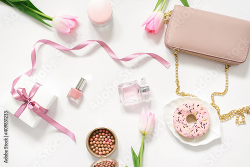 Valentine's Day, Mother Day, spring Concept with bag, donut, tulip pink and cosmetics. Top view. The view from the top. Trending concept for a blogger