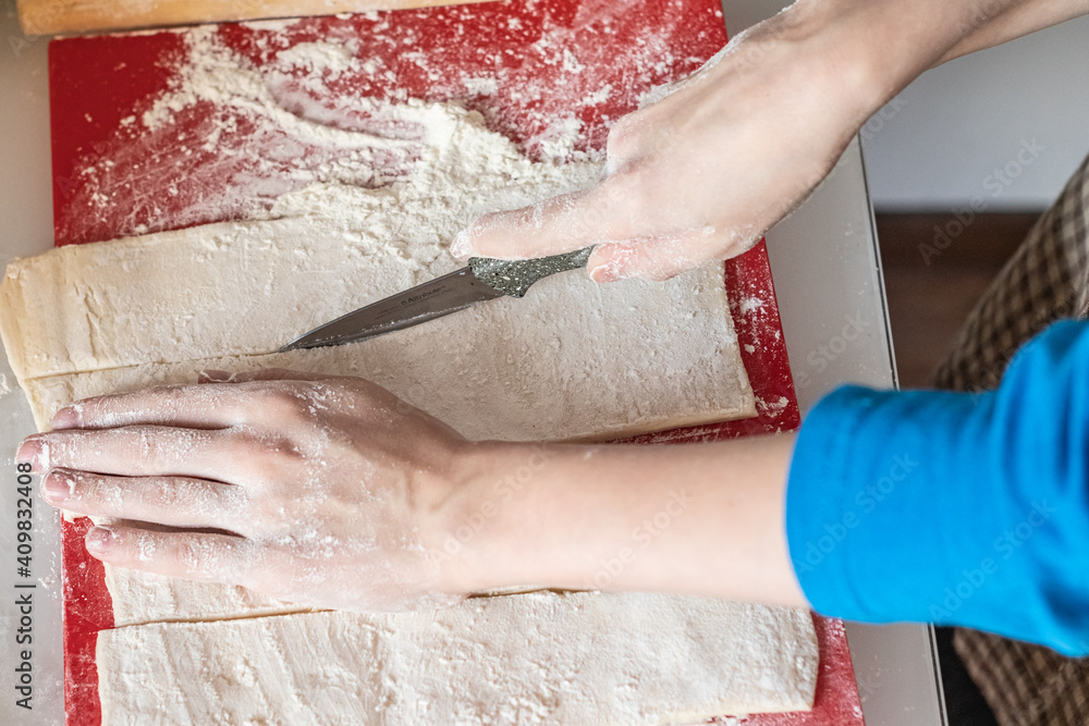 cuts the dough with a knife kitchen - obrazy, fototapety, plakaty 