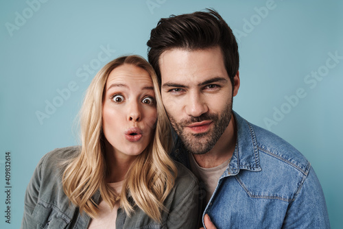 Young happy man and woman posing and looking at camera
