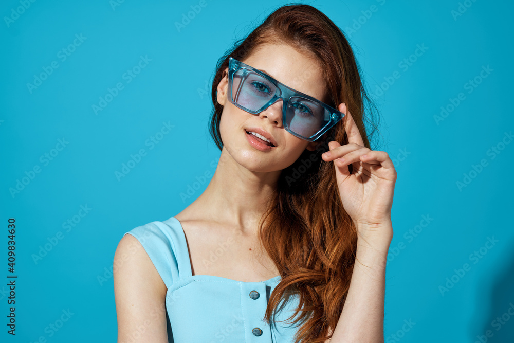 pretty woman in blue glasses with phone in hands communication technology isolated background