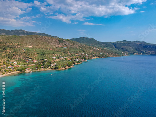 Aerial view over Santova coastal area in Messinia, Greece. Summer scenery with beautiful seaside bars and tourists in Santova near Kalamata city, Greece © panosk18