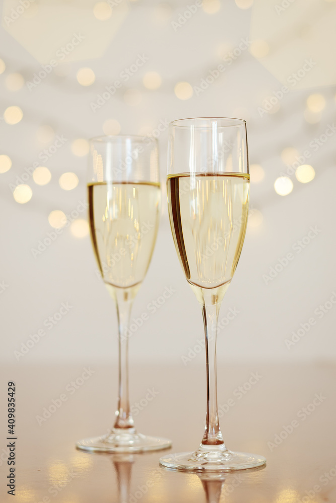 Two glasses of wine with bokeh background close up. Top view. New Year, Christmas mood. Greeting card. Party and holiday celebration concept. Two glasses of wine with bokeh background close up. Top view. New Year, Christmas mood. Greeting card. Party and holiday celebration concept.