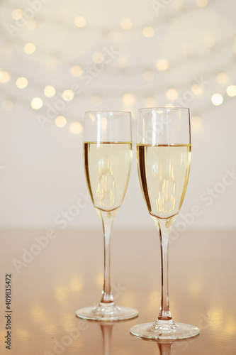 Two glasses of wine with bokeh background close up. Top view. New Year, Christmas mood. Greeting card. Party and holiday celebration concept.