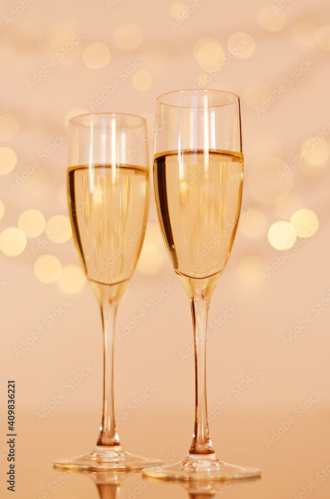 Two glasses of wine with bokeh background close up. Top view. New Year, Christmas mood. Greeting card. Party and holiday celebration concept.