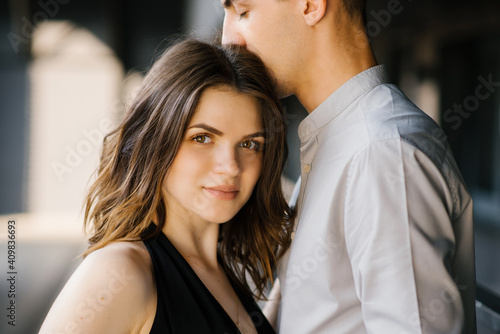 Head shot of young affectionate romantic couple in love.Concept of first kiss, tenderness and amorousness. Close up portrait of attractive brunette girl and guy with eyes closed, close to each other.