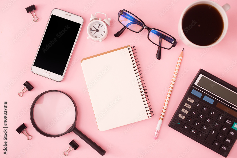 Search or choose a job. Career or freelance concept. Office supplies, notepad and phone and magnifier on a pink pastel background. Copy space, flat lay, top view. Search or choose a job. Career or freelance concept. Office supplies, notepad and phone and magnifier on a pink pastel background. Copy space, flat lay, top view.