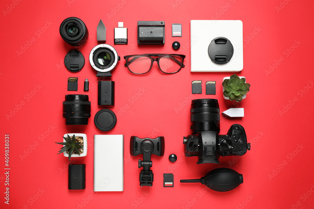 Flat lay composition with camera and video production equipment on red background. Space for text Flat lay composition with camera and video production equipment on red background. Space for text