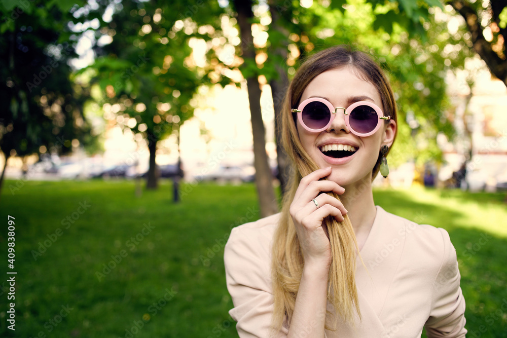 Pretty woman wearing sunglasses cropped view of green grass fresh air Pretty woman wearing sunglasses cropped view of green grass fresh air
