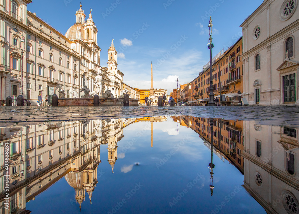 
Rome, Italy - in Winter time, frequent rain showers create pools in which the wonderful Old Town of Rome reflect like in a mirror. Here in particular Piazza Navona