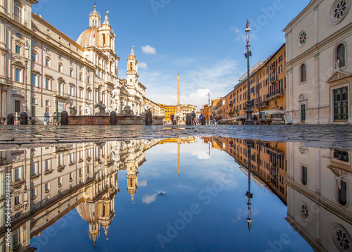  Rome, Italy - in Winter time, frequent rain showers create pools in which the wonderful Old Town of Rome reflect like in a mirror. Here in particular Piazza Navona
