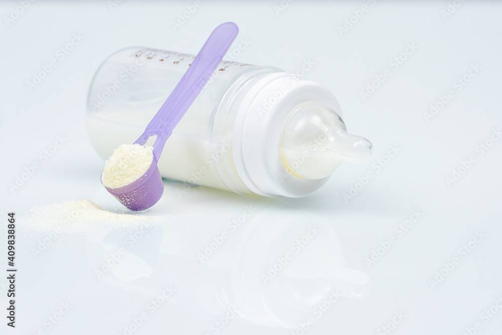 Baby milk bottle, Baby food. Powder in spoon and baby bottle Baby milk bottle, Baby food. Powder in spoon and baby bottle