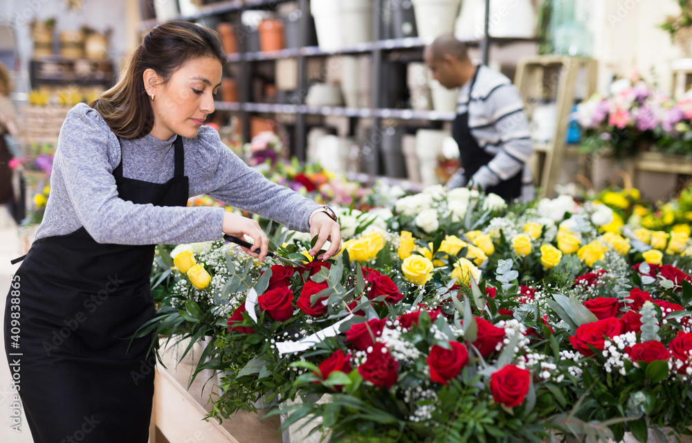 Flower seller prepares a luxury bouquet at a flower shop